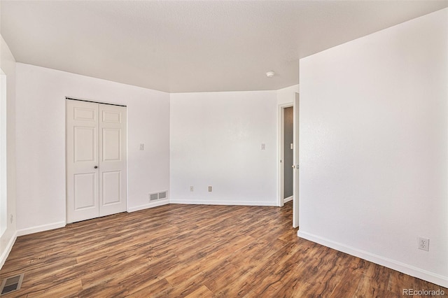 spare room featuring dark wood-type flooring