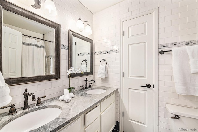 bathroom featuring decorative backsplash, tile walls, vanity, and a shower with curtain