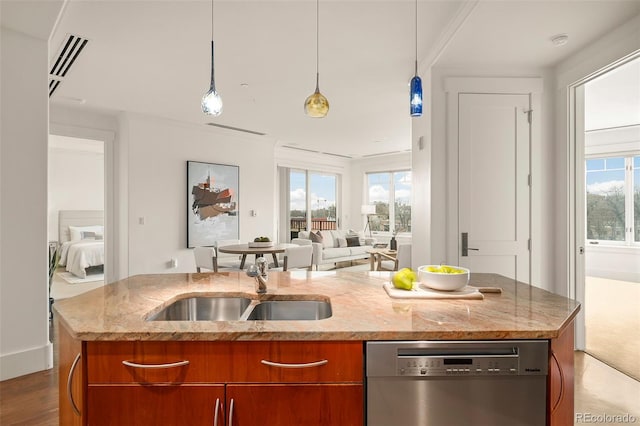 kitchen with a sink, open floor plan, light stone countertops, dishwasher, and brown cabinetry