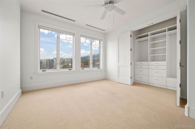 unfurnished bedroom with baseboards, visible vents, and light colored carpet