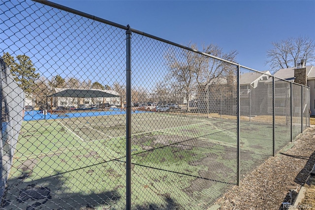 view of tennis court with fence