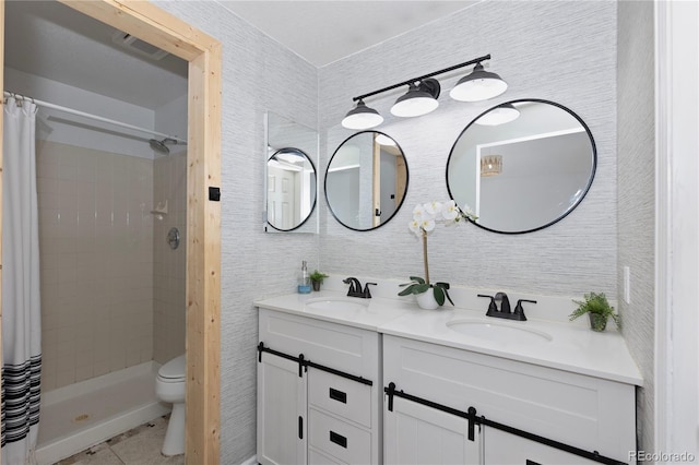 full bathroom with visible vents, a sink, a shower stall, and double vanity