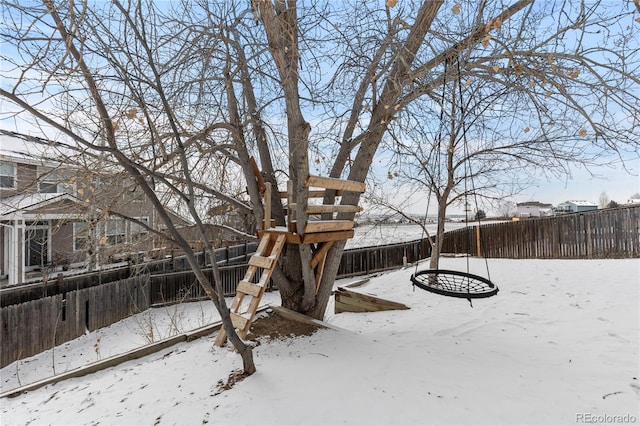 yard layered in snow with a fenced backyard