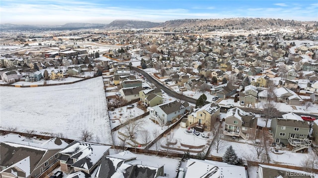 snowy aerial view with a residential view