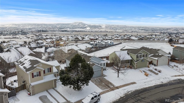 snowy aerial view with a residential view