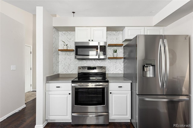 kitchen featuring stainless steel appliances, white cabinets, decorative backsplash, and open shelves