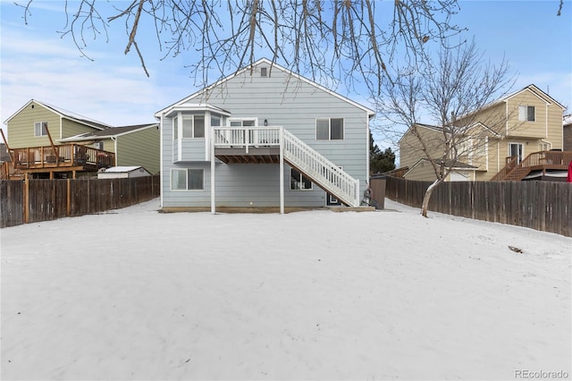 back of house featuring a fenced backyard, stairs, and a deck