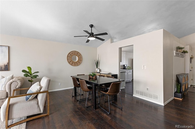 dining room featuring visible vents, vaulted ceiling, baseboards, and hardwood / wood-style flooring