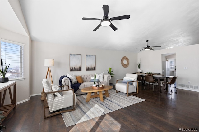 living area featuring visible vents, ceiling fan, baseboards, and hardwood / wood-style flooring