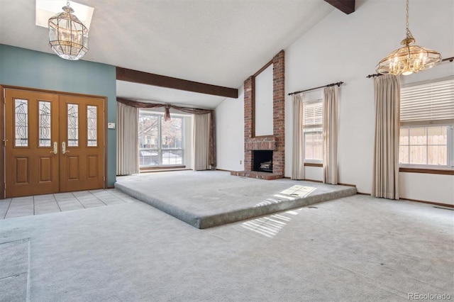 unfurnished living room with a healthy amount of sunlight, light carpet, and a fireplace