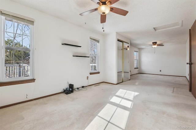 unfurnished living room featuring a wealth of natural light and light colored carpet