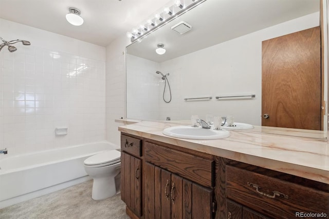 full bathroom with toilet, vanity, and tiled shower / bath combo