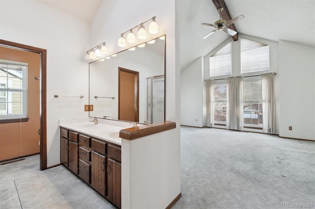 bathroom featuring a textured ceiling, high vaulted ceiling, ceiling fan, beamed ceiling, and vanity