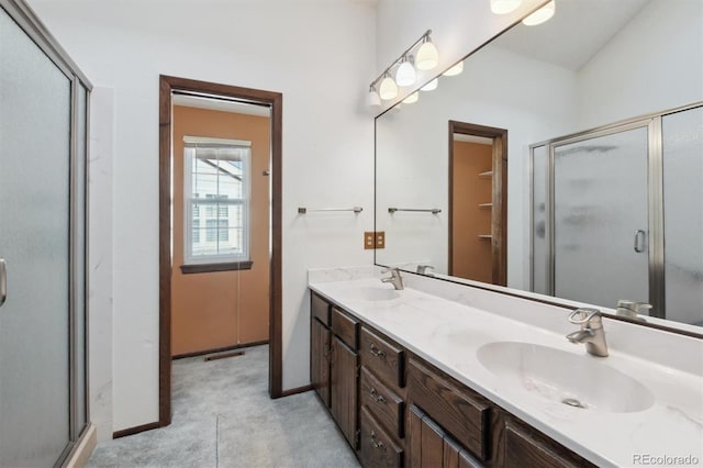 bathroom with a shower with door and vanity