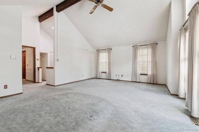 empty room with light colored carpet, high vaulted ceiling, ceiling fan, and beam ceiling