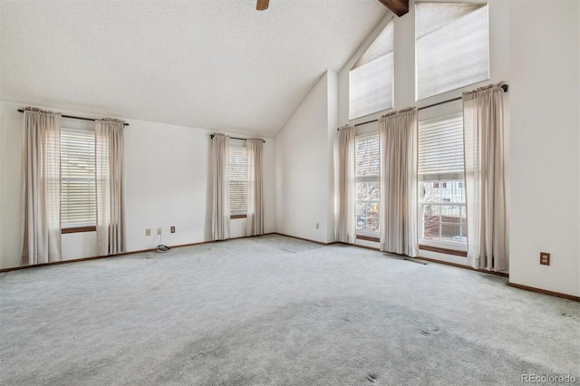 carpeted spare room with a textured ceiling and lofted ceiling with beams