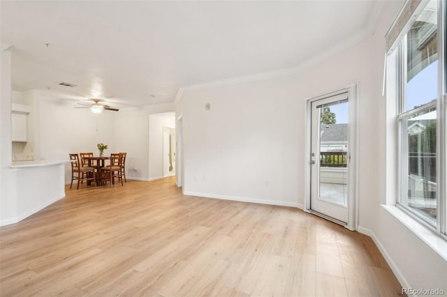 unfurnished living room featuring crown molding, ceiling fan, light wood-style flooring, baseboards, and visible vents