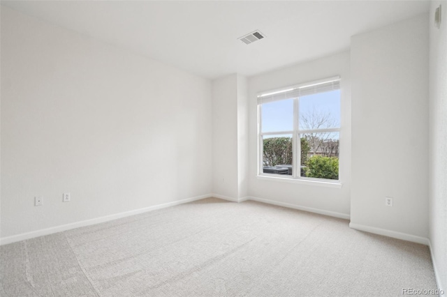 unfurnished room featuring baseboards, carpet flooring, and visible vents
