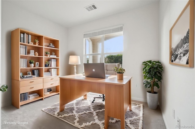 office area featuring visible vents and light carpet
