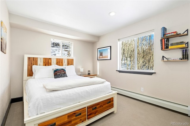 bedroom featuring light colored carpet and baseboard heating