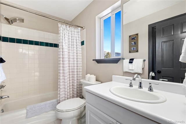 full bathroom with vanity, shower / tub combo with curtain, and toilet