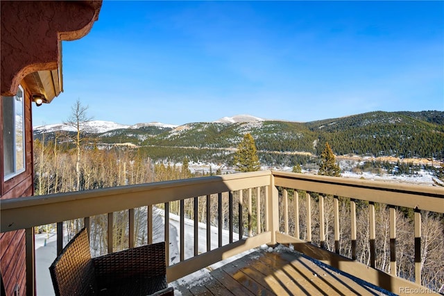 snow covered deck featuring a mountain view