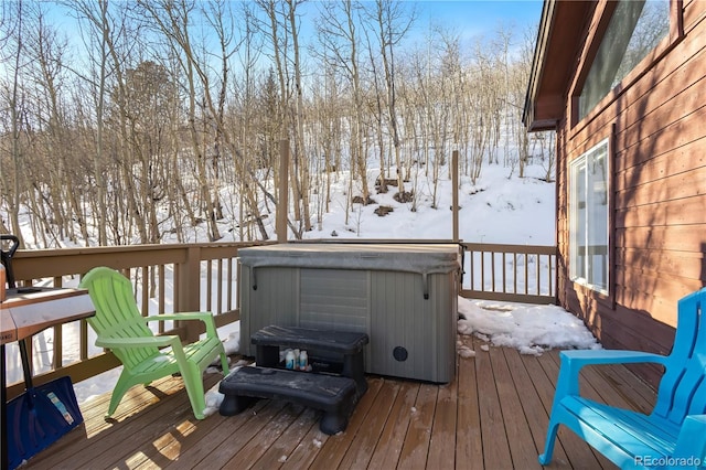 snow covered deck featuring a hot tub