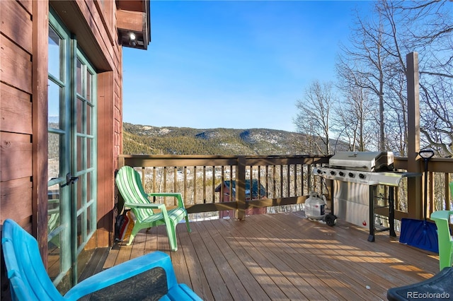 wooden deck featuring grilling area and a mountain view