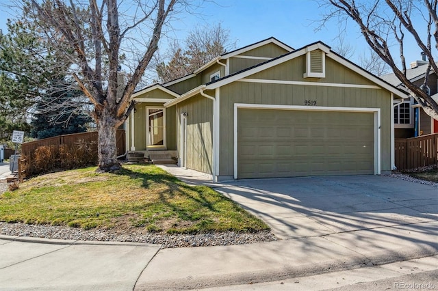 view of front of property featuring concrete driveway, fence, a garage, and a front lawn