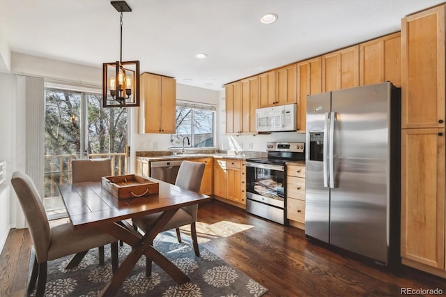 kitchen with recessed lighting, dark wood-style flooring, a sink, hanging light fixtures, and appliances with stainless steel finishes