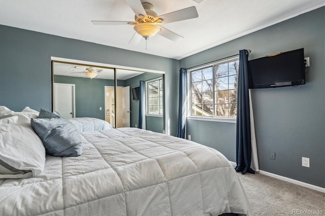 carpeted bedroom with baseboards, a closet, and ceiling fan