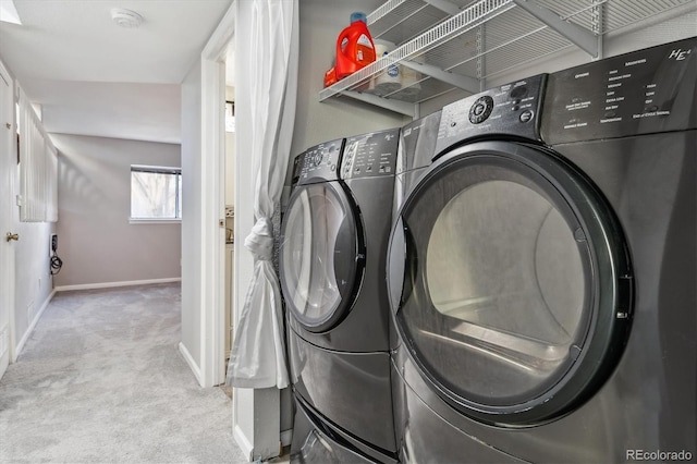 washroom featuring baseboards, carpet floors, separate washer and dryer, and laundry area