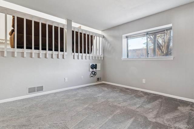 carpeted empty room with visible vents and baseboards