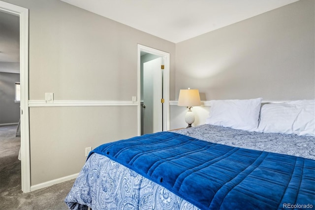 carpeted bedroom featuring baseboards