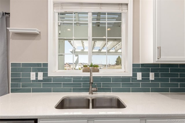 2881 Black Canyon Way, Castle Rock, CO 80109 - kitchen featuring white cabinets, decorative backsplash, dishwashing machine, and a sink