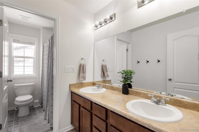 2881 Black Canyon Way, Castle Rock, CO 80109 - bathroom with double vanity, tile patterned floors, toilet, and a sink