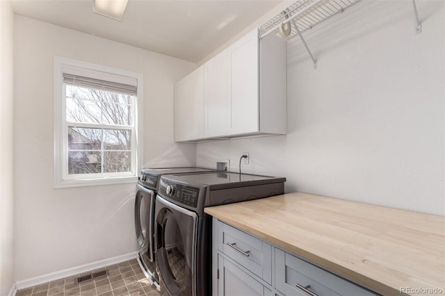 2881 Black Canyon Way, Castle Rock, CO 80109 - laundry room featuring washer and dryer, baseboards, cabinet space, and visible vents