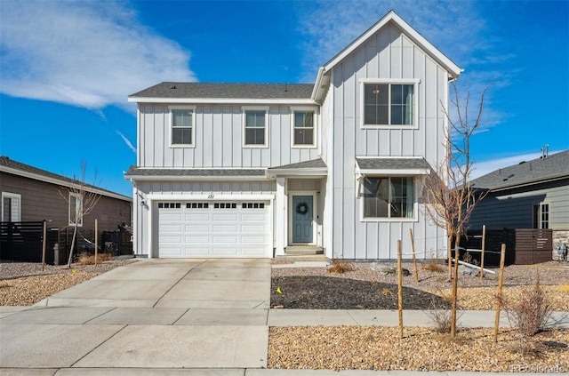 view of front facade with board and batten siding, concrete driveway, roof with shingles, and an attached garage