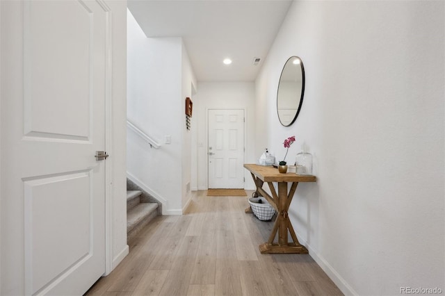 interior space with recessed lighting, visible vents, light wood-style flooring, baseboards, and stairs