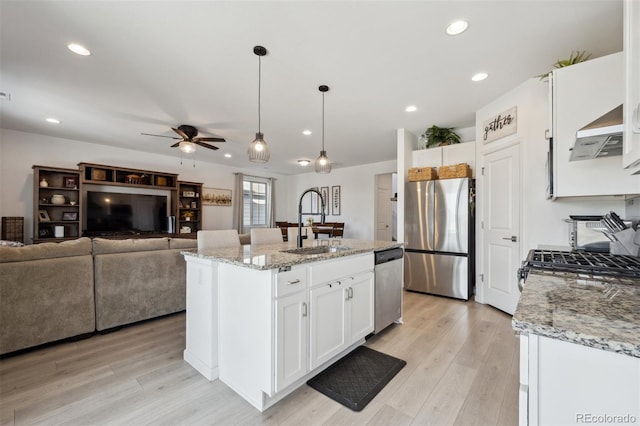 kitchen featuring light stone countertops, white cabinetry, and stainless steel appliances