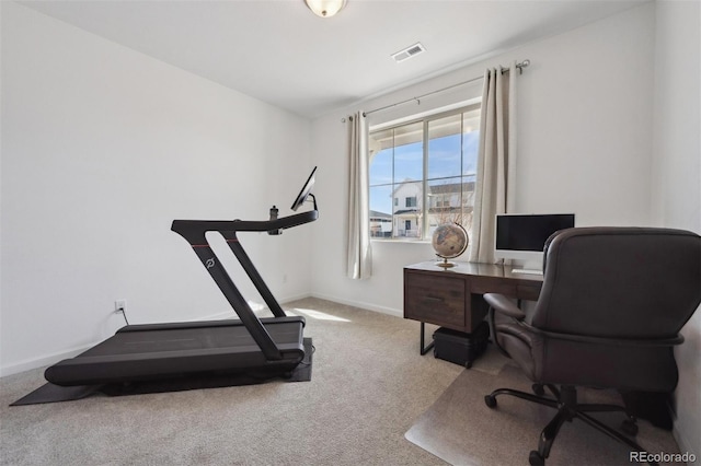 office featuring light carpet, baseboards, and visible vents