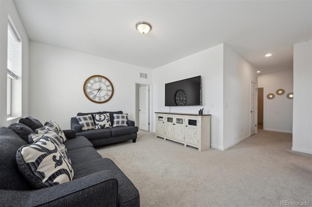 living room with recessed lighting, baseboards, visible vents, and light colored carpet