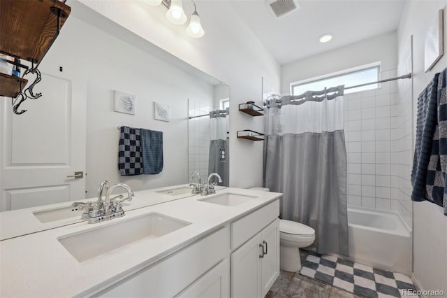 bathroom with double vanity, shower / bath combo, a sink, and visible vents