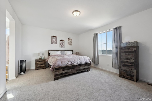 bedroom featuring visible vents, baseboards, and light colored carpet