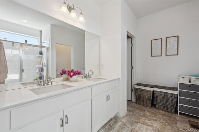 full bath featuring double vanity, a stall shower, and a sink