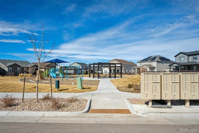 view of home's community with playground community, a residential view, and mail area