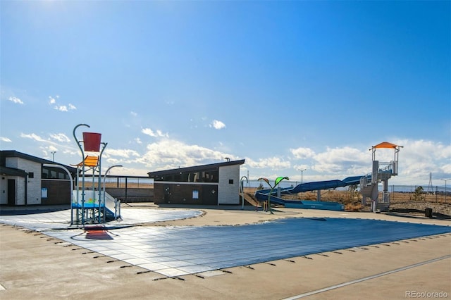 view of pool with playground community