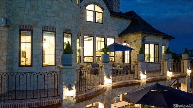 15355 Zuni St, Broomfield, CO 80023 - property exterior at twilight featuring stone siding and a chimney