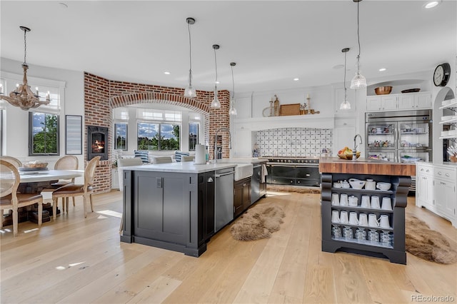 15355 Zuni St, Broomfield, CO 80023 - kitchen featuring open shelves, a sink, an island with sink, and recessed lighting
