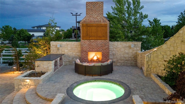 15355 Zuni St, Broomfield, CO 80023 - view of patio with an outdoor brick fireplace and an in-ground hot tub